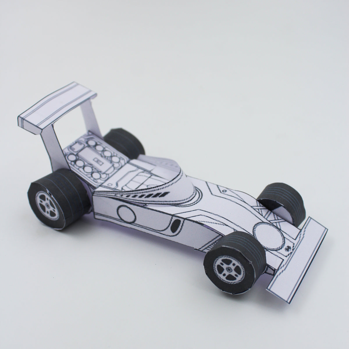 An image of a meticulously crafted F1 Car Paper Craft Toy, showcasing its realistic design and intricate details. Perfect for Formula 1 enthusiasts and creative minds.